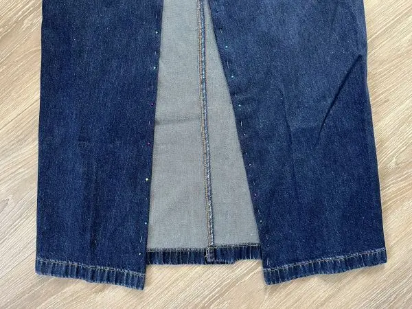 Damit dein neuer Rock nicht zu eng wird, solltest du vorne oder hinten in deiner alten Jeans einen Schlitz lassen und die Ränder abstecken. Damit dein neuer Rock nicht zu eng wird, solltest du vorne oder hinten in deiner alten Jeans einen Schlitz lassen unddie Ränder abstecken.