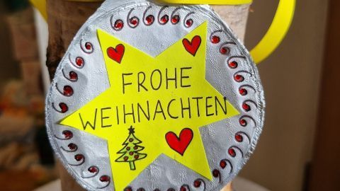 Verleihe deinen Weihnachtsgeschenken eine persönliche Note mit selbstgemachten Anhängern aus recycelten Joghurtdeckeln. Der festliche Stern und die bunten Verzierungen bringen Freude unter den Weihnachtsbaum.